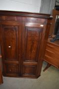 A 19th Century mahogany corner cupboard having panelled doors