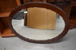 A 20th Century mahogany oval wall mirror