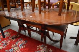 A reproduction Regency extending dining table of typical design