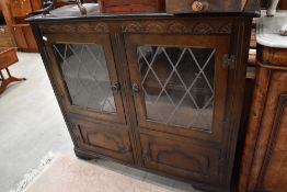 A reproduction priory style unit, having leaded glass to front.
