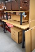 A modern tiered oak effect office desk and set of locking drawers.