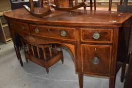 A late Georgian side board having curved front with inlayed details on tapered legs original handles