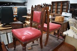 A set of six Victorian dining chairs having carved backs and red leather overstuffed seats