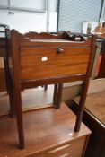 A 19th Century mahogany night stand with storage under drop flap