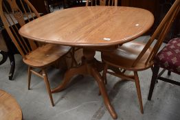A modern light elm Ercol extending dining table