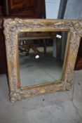 A reproduction gilt frame mirror