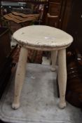 A antique painted milking style stool.