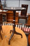 A 19th Century oak occasional wine or similar table having circular top turned column and tripod