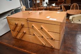 A vintage cantilever sewing box and contents including cotton reels etc