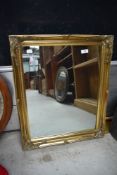 A reproduction gilt frame wall mirror