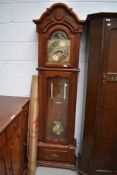 A reproduction long case clock having stained frame case, and brass face