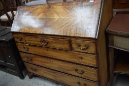 An early Victorian bureau chest of drawers having fitted interior with banded decoration and heart
