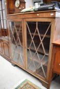 An early 20th Century bleached mahogany bookcase on bracket feet