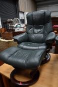 A Stressless recliner armchair and similar footstool