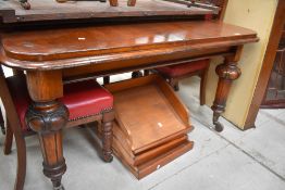 A Victorian windout dining table on turned legs and large pot castors