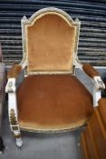 A French style painted armchair having gold dralon upholstery
