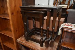 A nest of stained oak topped tables.