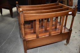 A Victorian Canterbury having mahogany frame on brass castors