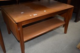 A vintage teak drop leaf coffee table