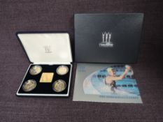 A Royal Mint 2002 Commonwealth Games silver proof four coin set with gold plated silver inner disc
