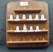 A group of ten silver thimbles, various, decoration dates and makers, all housed on a modern thimble