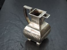 A Victorian silver cream jug, of square section baluster form with angular handle and half fluted