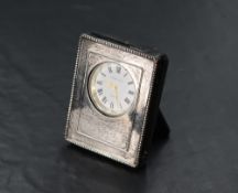 A small modern silver mounted desk clock, with moulded bead decoration and engraved initials,