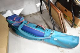A selection of golf clubs and retro bag