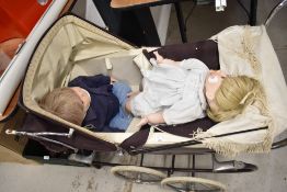 A Silver Cross Pram having double spoke wheels on suspension frame, brown body and hood with cream