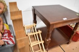 A modern side table with wall shelf and wine rack