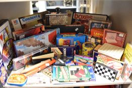 A large collection of retro board games, including pocket scrabble, pocket chess and checkers,