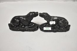 A pair of Victorian cast iron door stops in the form of mirrored spaniel dogs