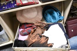 A suitcase of mixed vintage and retro clothing and accessories.