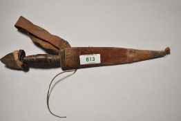 A late 19th century native American style dagger or knife in leather sheath