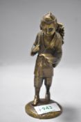 A Chinese Meiji period bronze figure of a wandering scholar or monk reading text book 14cm tall