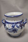 A large bulbous 19th century planter, having handles to sides, blue and white transfer pattern and
