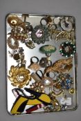 A tray of costume jewellery broaches, clip on earrings, etc