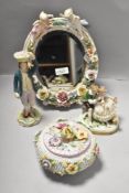 A selection of German style porcelain including cherub and foliate mirror AF, figure group marked