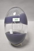 A 20th century studio art glass egg form having double purple colour band