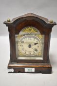 Early 20th century oak cased small sized bracket clock having ormolu decorated dial