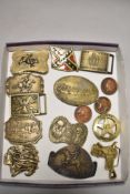 Fifteen metal belt buckles of American interest, including brass saddle and red Indian.