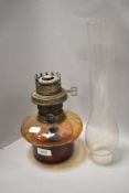 An oil lamp having yellow glass well with chimney