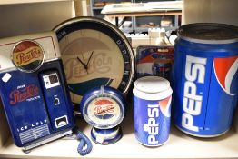 A mixed lot of retro Pepsi-Cola collectables, amongst which are a telephone, cassette player, clocks