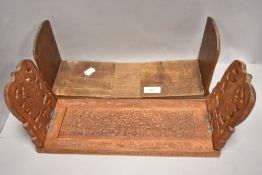 Two 20th century book shelf stands including Arts and Crafts style and Indian wooden carved