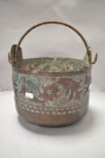An Arts and Crafts style antique coal or similar bucket in copper having hand worked design