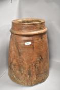 A large one piece carved wood bucket or grain bin