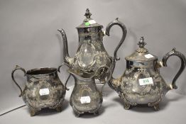 A Victorian pewter tea set having chase work design with foliate feet