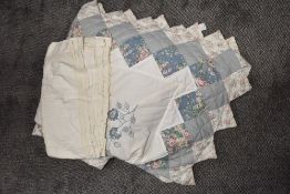 A large vintage style floral bed throw and a large table cloth having crotcheted panels.