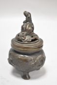 A 19th century Japanese bronze censor or Koro having pierced dog of fo lid with three footed plant