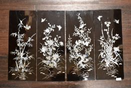 Four decorative lacquered panels having detailed mother of pearl inlaid scenes of foliage, birds and